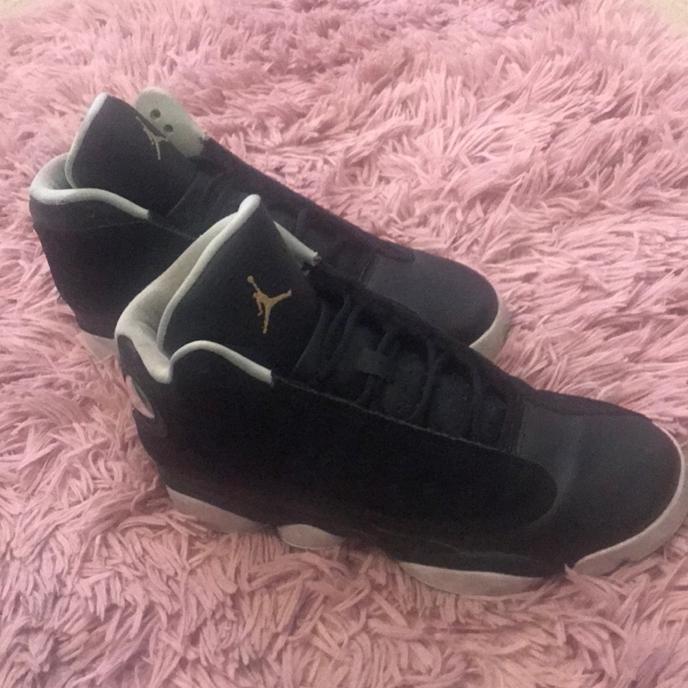 Black Jordan 13’s with a teal accent